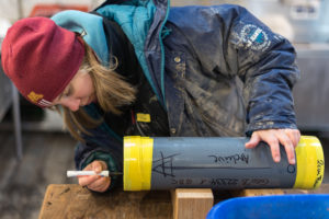 Me, labelling core liners where the collected material (ocean mud or as we say, sediments) is archived inside. (Credit: Volker Diekamp)